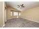 Large bedroom with plush carpet, vaulted ceiling, and natural light from windows at 5676 Bettors Luck Ct, Las Vegas, NV 89122