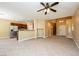 Bright, open-concept living room, adjacent kitchen with stainless appliances and tile floors at 5676 Bettors Luck Ct, Las Vegas, NV 89122