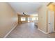 Large living room space with tile flooring, a ceiling fan, and bright natural light at 5676 Bettors Luck Ct, Las Vegas, NV 89122
