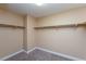 An empty carpeted walk-in closet with metal racks for ample storage at 5676 Bettors Luck Ct, Las Vegas, NV 89122