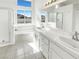 Bathroom featuring double sinks, tiled countertops, and a glass-enclosed shower offering a clean, modern aesthetic at 676 Covina Dr, Henderson, NV 89002