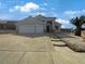 Charming single-story home featuring a well-manicured yard and a spacious three-car garage, complete with a tile roof at 676 Covina Dr, Henderson, NV 89002
