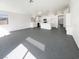 Open-concept living area with tile floors and abundant natural light, seamlessly connecting living and kitchen spaces at 676 Covina Dr, Henderson, NV 89002