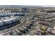 An elevated view shows a community of modern homes with palm tree-lined streets, and city views in the distance at 6848 Calvitero St, Las Vegas, NV 89149