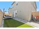 Compact backyard with artificial turf, stone pathway, a bench, and a grill for outdoor enjoyment at 6848 Calvitero St, Las Vegas, NV 89149