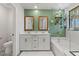 Bathroom with dual sinks, tub, shower, decorative tile and a plant shelf at 6848 Calvitero St, Las Vegas, NV 89149