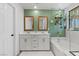 Bathroom with dual sinks, tub, shower, decorative tile and a plant shelf at 6848 Calvitero St, Las Vegas, NV 89149
