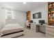 Well-organized bedroom and workspace featuring a decorative headboard, with neutral carpet at 6848 Calvitero St, Las Vegas, NV 89149