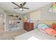 Cozy bedroom featuring plush toys, neutral tones, and a modern ceiling fan for comfortable living at 6848 Calvitero St, Las Vegas, NV 89149