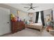 Comfortable bedroom with natural light, fan, dresser and carpet flooring at 6848 Calvitero St, Las Vegas, NV 89149