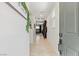 Inviting hallway with neutral tile flooring, decor, and bright natural light creates a welcoming entrance at 6848 Calvitero St, Las Vegas, NV 89149
