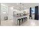 Bright kitchen with white cabinets, stainless steel appliances, and a breakfast bar with seating at 6848 Calvitero St, Las Vegas, NV 89149