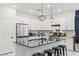 Modern kitchen features white cabinets, stainless steel appliances, and a black countertop island at 6848 Calvitero St, Las Vegas, NV 89149