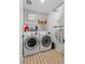 Convenient laundry room with washer, dryer, and stylish patterned wallpaper at 6848 Calvitero St, Las Vegas, NV 89149