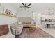 Inviting living area with a sectional sofa, modern decor, and an open layout leading to the kitchen at 6848 Calvitero St, Las Vegas, NV 89149