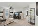 Bright, carpeted loft with ceiling fan and a view of the hallway to the bedrooms at 6848 Calvitero St, Las Vegas, NV 89149