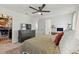 Bright main bedroom with a ceiling fan, dresser, walk-in closet, and neutral décor at 6848 Calvitero St, Las Vegas, NV 89149