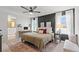 Spacious main bedroom suite with dark accent wall, bright windows and an attached bathroom at 6848 Calvitero St, Las Vegas, NV 89149