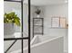 Modern staircase with sleek black shelving, potted plants, and decorative wall art at 6848 Calvitero St, Las Vegas, NV 89149