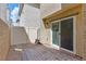 Private brick backyard with white fence and sliding glass door at 6850 Magenta Moon St, North Las Vegas, NV 89086