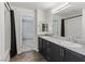 Stylish bathroom with double sinks, dark cabinetry, and a shower-tub, offering comfort and convenience at 6850 Magenta Moon St, North Las Vegas, NV 89086