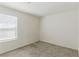 Bedroom with neutral carpet, white walls, natural light, and electrical outlets at 6850 Magenta Moon St, North Las Vegas, NV 89086