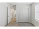 Bright bedroom with plush carpet, white sliding closet doors, and natural light at 6850 Magenta Moon St, North Las Vegas, NV 89086