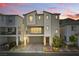 Charming two-story home boasts modern architecture, a balcony, and a well-maintained front yard at sunset at 6850 Magenta Moon St, North Las Vegas, NV 89086
