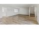 Spacious living room with hardwood floors, bright white walls, and staircase at 6850 Magenta Moon St, North Las Vegas, NV 89086