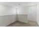 Bright loft with neutral carpet, white walls, and natural light from three windows at 6850 Magenta Moon St, North Las Vegas, NV 89086