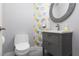 Stylish powder room featuring a modern vanity, decorative wallpaper, and sleek fixtures at 689 Principle Point Ave, Henderson, NV 89012