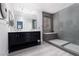 Modern bathroom features double vanity with marble countertop and oversized shower with window at 689 Principle Point Ave, Henderson, NV 89012