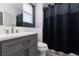 Modern bathroom with subway tile, vanity, and a shower with a stylish dark curtain at 689 Principle Point Ave, Henderson, NV 89012