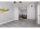 Open room with neutral walls and gray floors, offering closet and second story access at 689 Principle Point Ave, Henderson, NV 89012