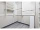 Bright walk-in closet featuring ample shelving and wood-look flooring at 689 Principle Point Ave, Henderson, NV 89012
