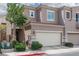 Multi-level home featuring neutral paint, well maintained landscaping, and attached two car garage at 689 Principle Point Ave, Henderson, NV 89012