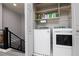 Laundry area with shelving, including new, modern washer and dryer at 689 Principle Point Ave, Henderson, NV 89012