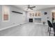 Elegant living room with a cozy fireplace, built-in shelving, and large windows at 689 Principle Point Ave, Henderson, NV 89012
