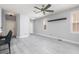 Spacious living room with a ceiling fan and natural light from large windows at 689 Principle Point Ave, Henderson, NV 89012