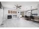 Open-concept living and kitchen features fireplace and updated appliances with barstool seating at 689 Principle Point Ave, Henderson, NV 89012