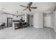 Open-concept living area featuring modern kitchen with breakfast bar and dining space at 689 Principle Point Ave, Henderson, NV 89012