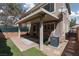 Backyard patio with brick flooring, covered area, and artificial turf landscaping at 689 Principle Point Ave, Henderson, NV 89012