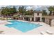 Sparkling community pool with lounge chairs, shade, and beautiful landscaping at 689 Principle Point Ave, Henderson, NV 89012