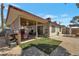 Large backyard with a covered patio, gravel landscaping, and a small lawn area, perfect for outdoor activities at 7055 Sylvan Oak Dr, Las Vegas, NV 89147