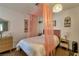 Serene bedroom with a pink-themed decor, featuring a canopy bed, modern lighting, and a cozy atmosphere at 7055 Sylvan Oak Dr, Las Vegas, NV 89147