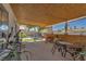 Inviting covered patio with a bamboo ceiling, outdoor seating, and views of the landscaped backyard at 7055 Sylvan Oak Dr, Las Vegas, NV 89147