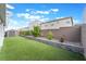 Beautiful backyard with artificial grass, a retaining wall, blooming flowers and a storage shed at 7307 Grace Estate Ave, Las Vegas, NV 89113