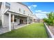 Expansive backyard featuring a covered patio, artificial turf, shed, and elegant landscaping at 7307 Grace Estate Ave, Las Vegas, NV 89113