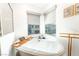 Bright bathroom with a soaking tub and windows providing a relaxing and airy atmosphere at 7307 Grace Estate Ave, Las Vegas, NV 89113