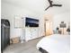 Bright bedroom with a dresser, television, ceiling fan, and neutral decor, creating a calming atmosphere at 7307 Grace Estate Ave, Las Vegas, NV 89113